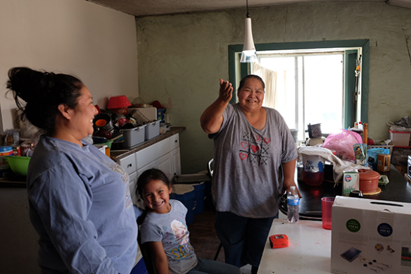 A Navajo family enjoys their newly installed solar light.