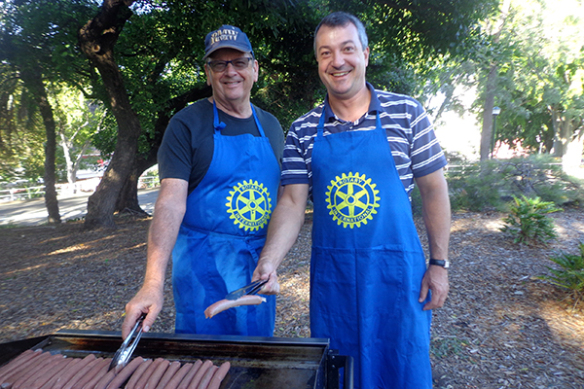 John Smerdon and Daniel Vankov prepare sausages for the homeless.