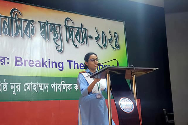 Young girl in front of podium delivering a message.