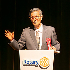 Dr. Omi at the podium